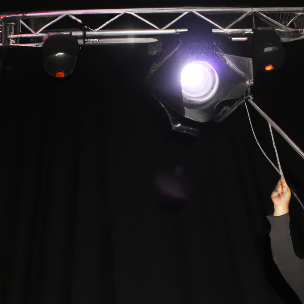 Person adjusting lighting on stage